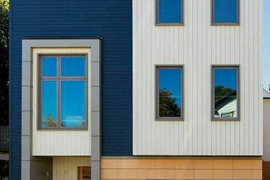 Mid-sized contemporary three-story mixed siding flat roof idea in Boston