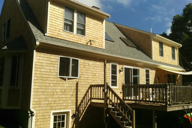 Example of a mid-sized classic brown two-story wood exterior home design in Boston with a shingle roof
