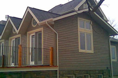 Idee per la facciata di una casa grande beige a due piani con rivestimento in legno