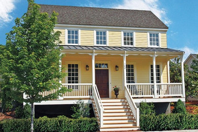 Inspiration for a timeless yellow two-story vinyl exterior home remodel in DC Metro with a shingle roof
