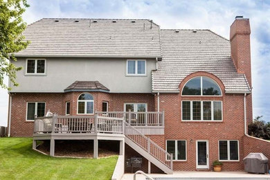 Red three-story mixed siding exterior home photo in Wichita