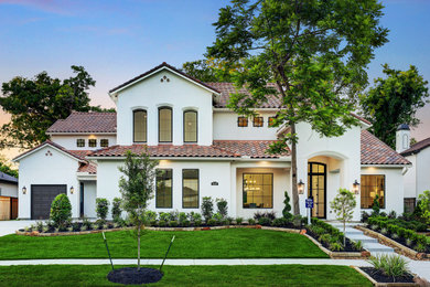 Example of a huge transitional white two-story stucco exterior home design in Houston with a tile roof