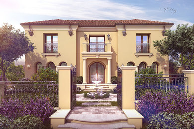 Inspiration for a large mediterranean yellow two-story stucco house exterior remodel in Los Angeles with a hip roof and a tile roof