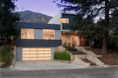 Diseño de fachada gris moderna de tamaño medio de dos plantas con revestimiento de aglomerado de cemento