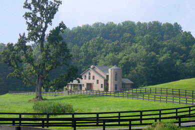 Example of a farmhouse brown two-story wood exterior home design in DC Metro