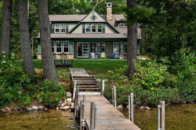 Beige classic two floor detached house in Boston with wood cladding, a pitched roof and a shingle roof.