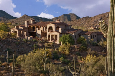 Large southwestern two-story stucco exterior home idea in Phoenix