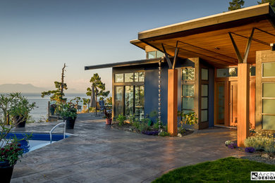 Example of a mid-sized trendy two-story mixed siding exterior home design in Vancouver with a shed roof