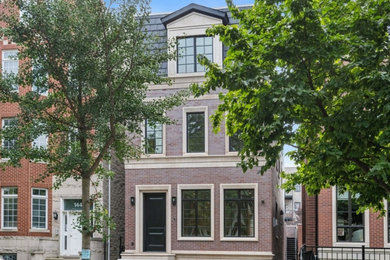 Large transitional brown three-story brick exterior home idea in Chicago