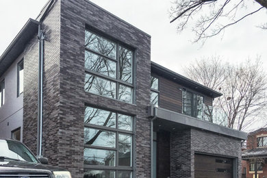 Minimalist gray brick exterior home photo in Other