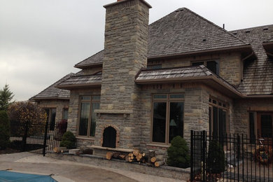 Mid-sized traditional stone exterior home idea in Toronto