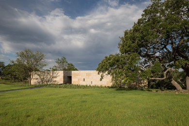 Example of a small minimalist one-story stone exterior home design in Austin