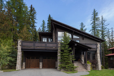 Mid-sized mountain style gray two-story wood exterior home photo in Calgary with a hip roof