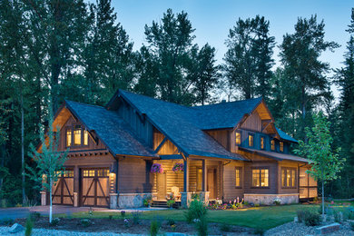 Mid-sized rustic brown two-story wood exterior home idea in Other with a shingle roof