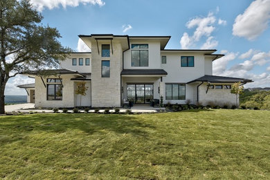 Large transitional white two-story mixed siding exterior home photo in Austin