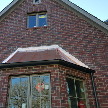 Slate Roof with Copper standing seam over bay windows