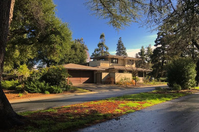 Mid-sized mid-century modern beige two-story mixed siding house exterior photo in San Francisco with a hip roof and a shingle roof