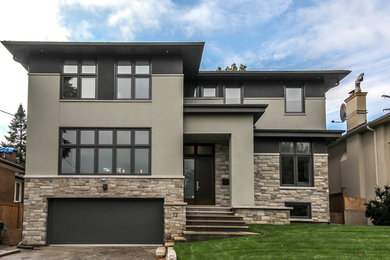 Example of a large trendy multicolored two-story stucco exterior home design in Toronto