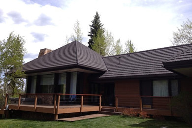 Large elegant brown one-story wood gable roof photo in Denver