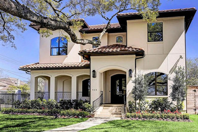 Inspiration for a large and beige contemporary two floor render detached house in Houston with a hip roof and a tiled roof.
