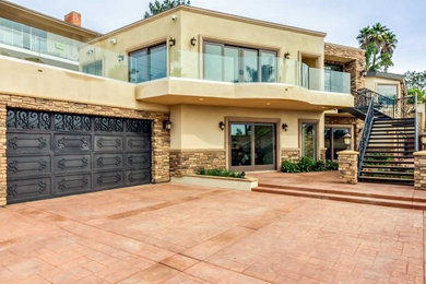 Inspiration for a large contemporary beige two-story mixed siding flat roof remodel in San Diego