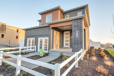 Photo of a large and gey contemporary two floor detached house in Salt Lake City with mixed cladding, a flat roof and a shingle roof.