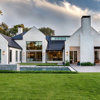 Transitional white two-story brick exterior home idea in Houston