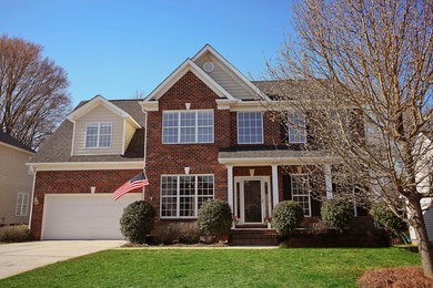 Inspiration for a timeless two-story brick exterior home remodel in Charlotte