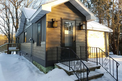 Diseño de fachada de casa gris de estilo americano de tamaño medio de una planta con revestimiento de vinilo, tejado a dos aguas y tejado de teja de madera