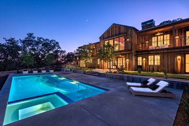 Example of a large mountain style brown two-story wood exterior home design in San Francisco with a metal roof