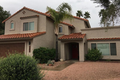Mid-sized modern beige two-story stucco house exterior idea in Phoenix with a clipped gable roof and a tile roof