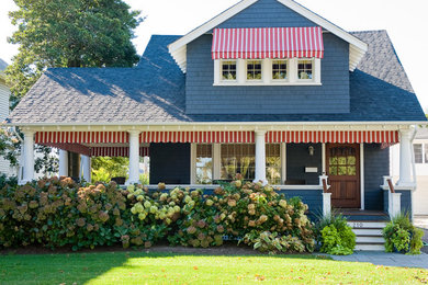 Example of a beach style blue two-story gable roof design in New York