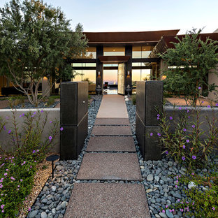 Large modern beige one-story adobe flat roof idea in Phoenix
