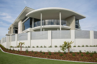 Inspiration for a white world-inspired two floor house exterior in Perth with stone cladding.