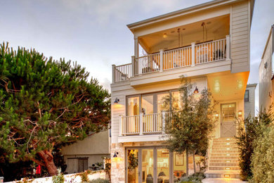 Example of a beach style beige three-story house exterior design in Los Angeles