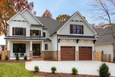 Elegant white mixed siding house exterior photo in Charlotte with a hip roof and a mixed material roof