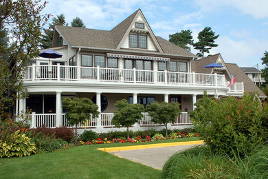 Example of a large classic white two-story wood exterior home design in Grand Rapids with a shingle roof