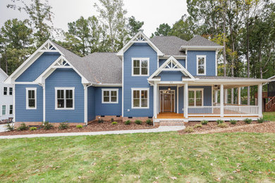 Mid-sized traditional blue two-story concrete fiberboard house exterior idea in Raleigh with a hip roof and a shingle roof