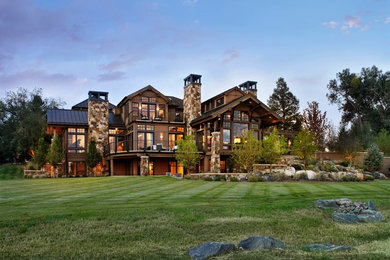 Example of a large mountain style three-story exterior home design in Denver