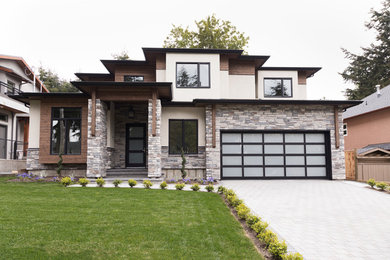 Photo of a beige contemporary detached house in Vancouver with wood cladding.