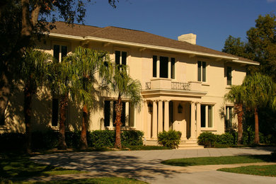Inspiration for a large timeless beige two-story stucco exterior home remodel in Tampa