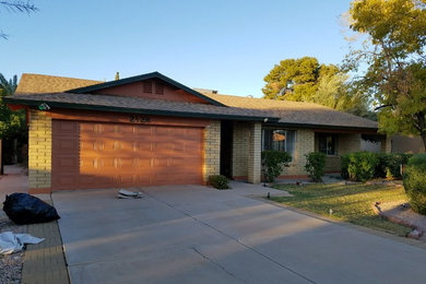 This is an example of a medium sized and beige traditional bungalow brick detached house in Phoenix with a shingle roof.