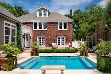 Inspiration for a large timeless red two-story brick house exterior remodel in Houston