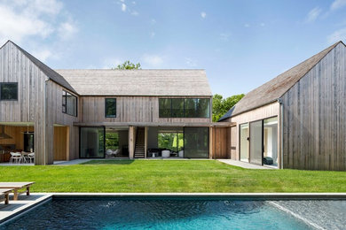 Country two-story wood exterior home photo in New York with a shingle roof