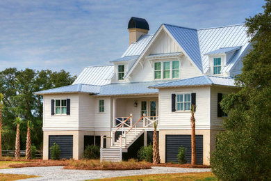 Inspiration for a coastal white two-story exterior home remodel in Charleston with a hip roof