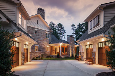 Large transitional white two-story stone house exterior photo in Charlotte with a hip roof and a shingle roof