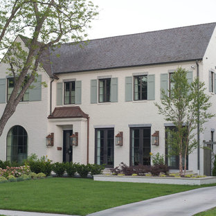Example of a large transitional white two-story brick exterior home design in Dallas with a tile roof