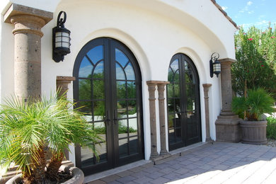 Inspiration for an expansive and white mediterranean two floor render house exterior in Phoenix.