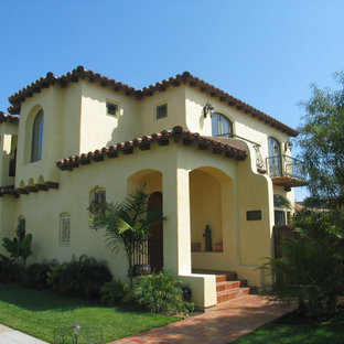 Inspiration for a large mediterranean beige two-story stucco gable roof remodel in San Diego