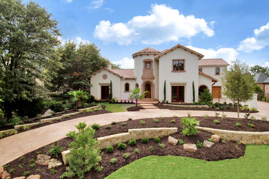 Large mediterranean white two-story stucco exterior home idea in Dallas with a tile roof